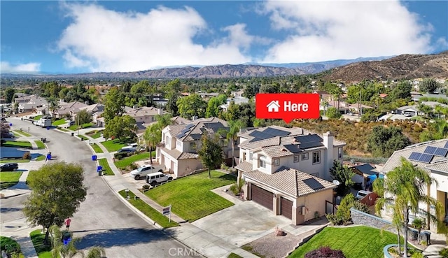 birds eye view of property with a mountain view