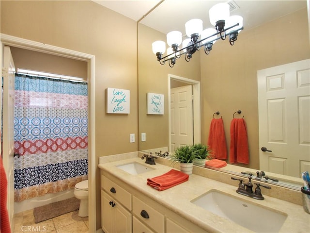 bathroom with toilet, tile patterned floors, vanity, and a notable chandelier