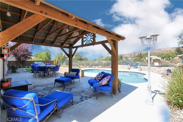 view of pool with a gazebo, a mountain view, and a patio