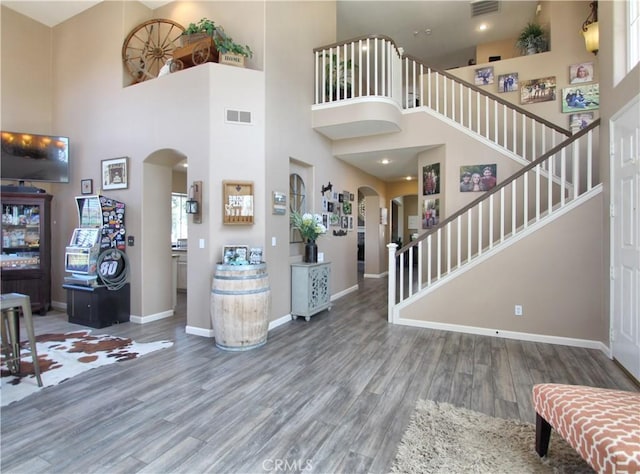 foyer featuring a high ceiling and wood-type flooring