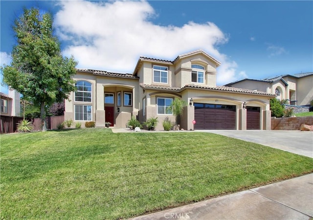 mediterranean / spanish house with a garage and a front lawn