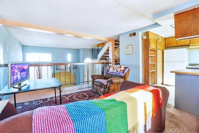 carpeted living room with a textured ceiling