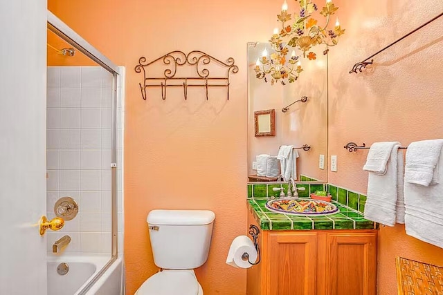 full bathroom featuring toilet, tiled shower / bath combo, and vanity