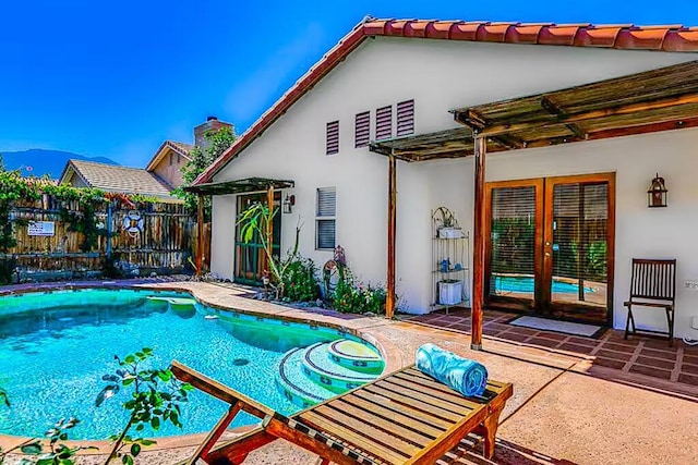 view of swimming pool with a mountain view and a patio