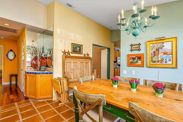 dining space featuring tile patterned floors and a notable chandelier