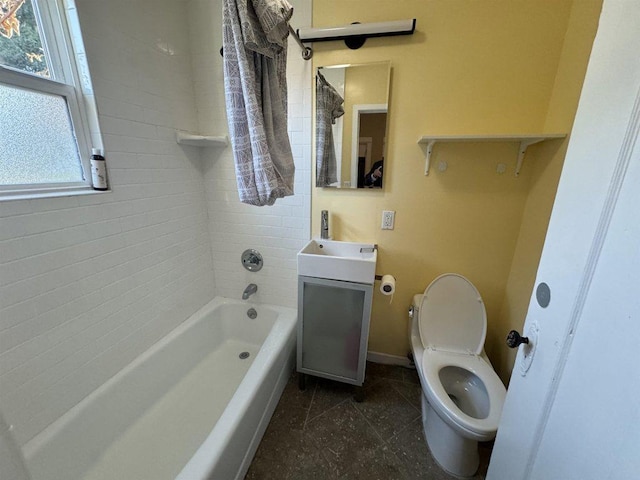 full bathroom with toilet, vanity, and tiled shower / bath