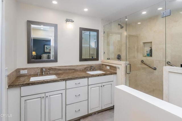 bathroom with vanity and a shower with door