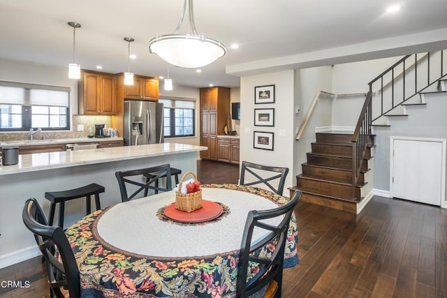 dining room featuring sink, dark hardwood / wood-style flooring, and plenty of natural light