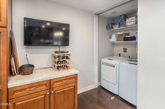 laundry room with washing machine and dryer and dark hardwood / wood-style flooring