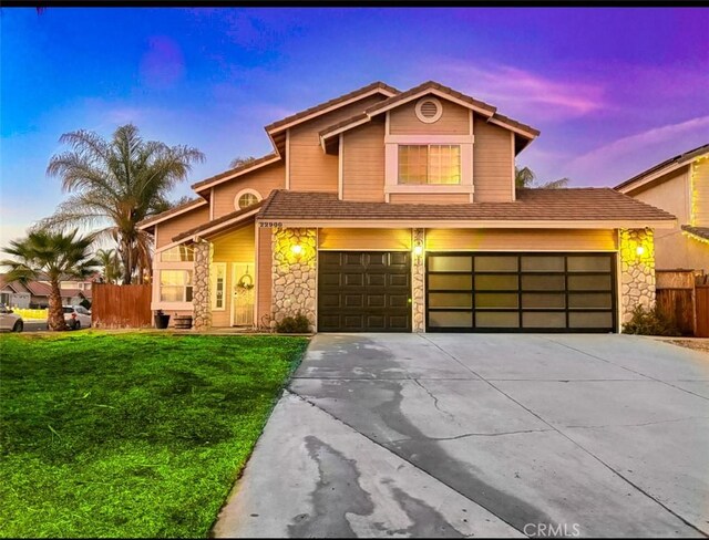 view of front of house featuring a garage and a yard