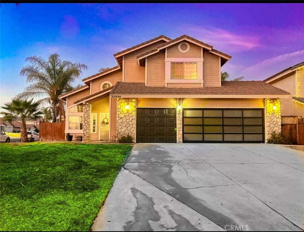 view of front of house with a yard and a garage