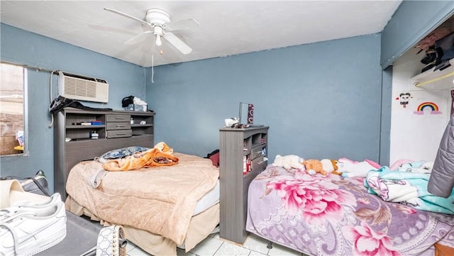 tiled bedroom with ceiling fan and a wall mounted AC