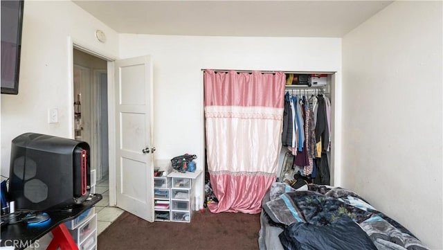 tiled bedroom with a closet