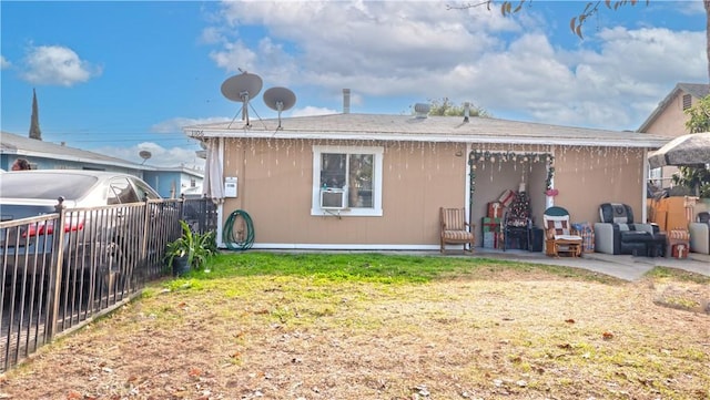 back of property featuring a lawn