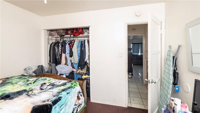 tiled bedroom with a closet