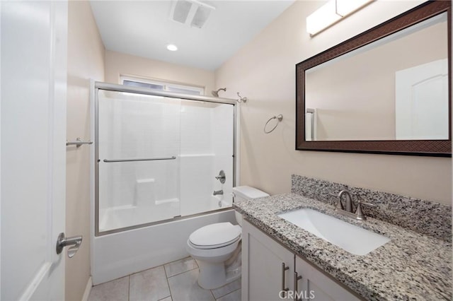 full bathroom with tile patterned floors, combined bath / shower with glass door, vanity, and toilet