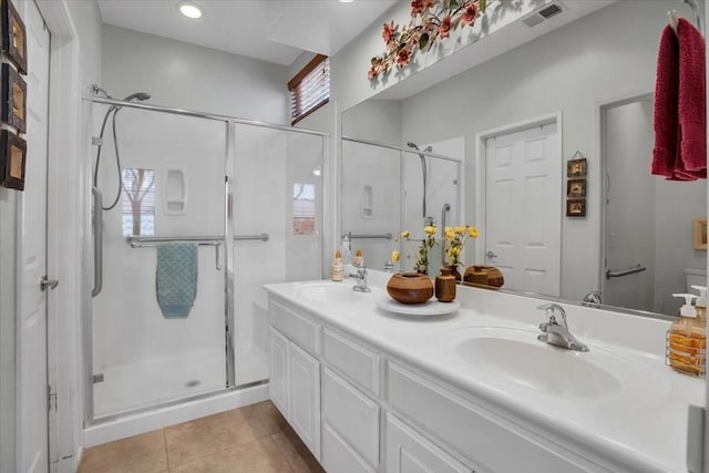 bathroom featuring an enclosed shower, vanity, and tile patterned flooring