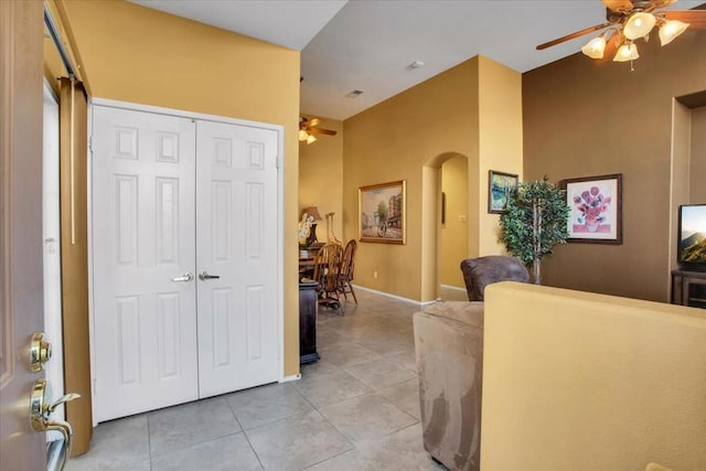 tiled foyer featuring ceiling fan