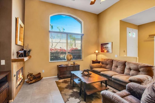 living room featuring ceiling fan and light tile patterned floors