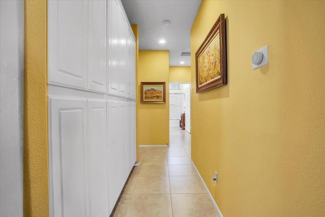 hall with light tile patterned floors