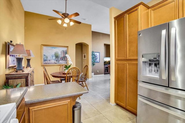 kitchen with ceiling fan, light tile patterned floors, and stainless steel fridge