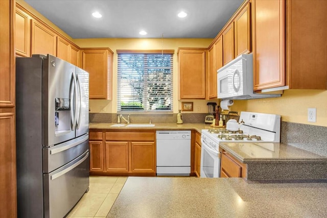 kitchen featuring light tile patterned flooring, sink, and white appliances