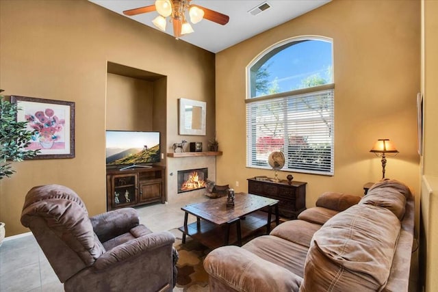 living room featuring ceiling fan and light tile patterned floors