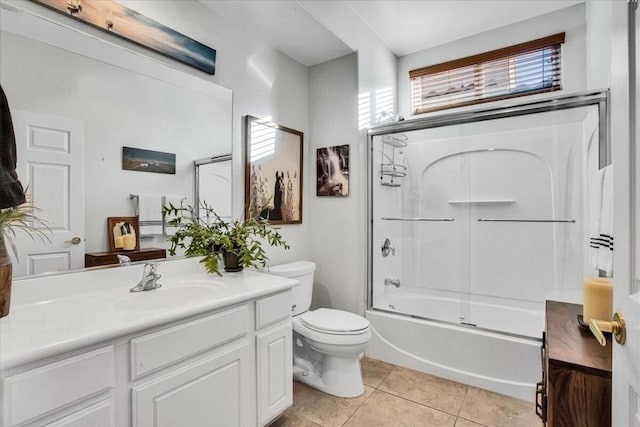 full bathroom featuring toilet, vanity, tile patterned flooring, and shower / bath combination with glass door