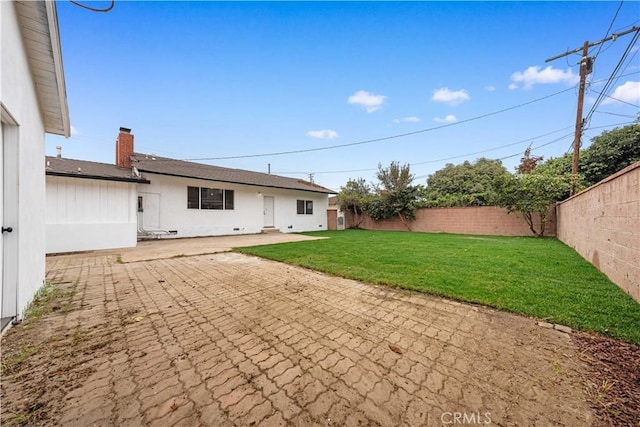 rear view of property with a patio area and a lawn