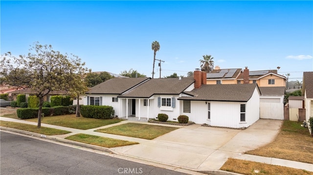 ranch-style house featuring a front lawn and solar panels