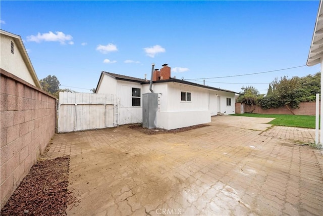 back of property with a patio