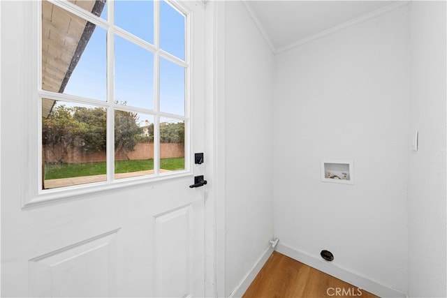 laundry area featuring washer hookup, plenty of natural light, crown molding, and hardwood / wood-style flooring