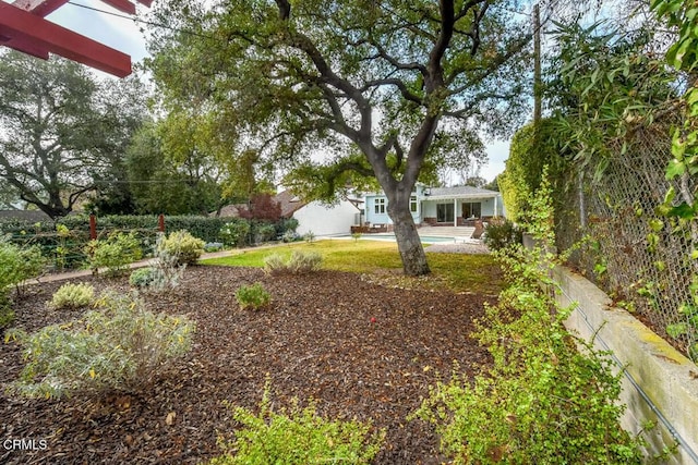 view of yard with a fenced in pool