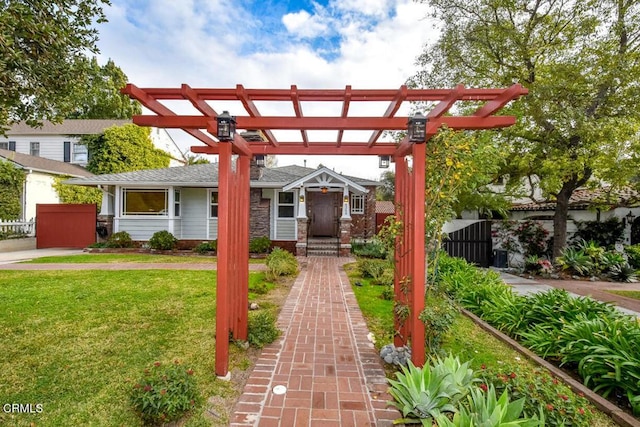 view of property's community with a lawn and a pergola