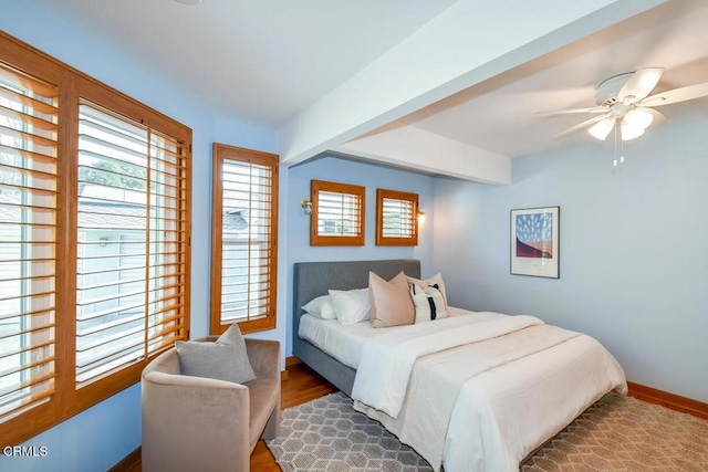 bedroom featuring ceiling fan and dark hardwood / wood-style floors