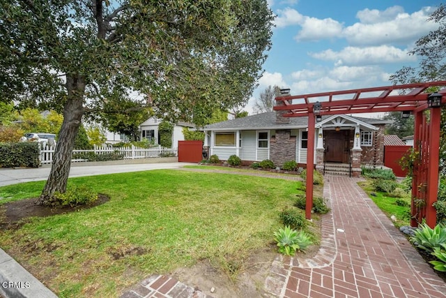 view of front of house with a front yard and a pergola