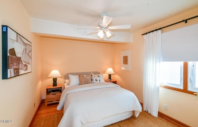 bedroom with ceiling fan and light hardwood / wood-style floors