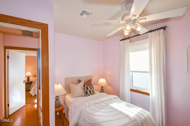 bedroom with ceiling fan and light wood-type flooring