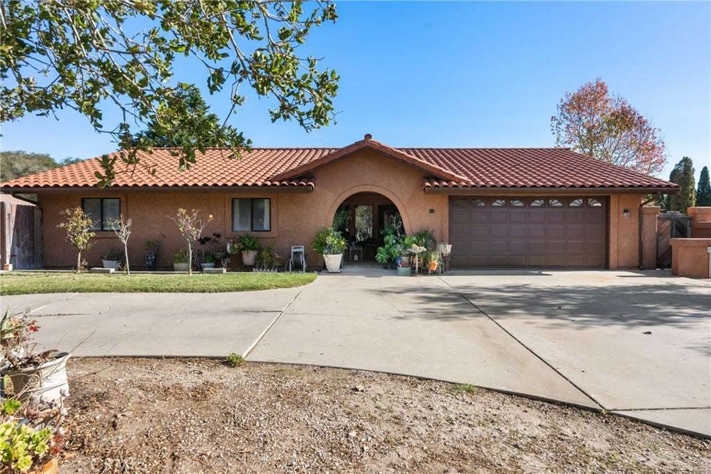 mediterranean / spanish-style home with a garage