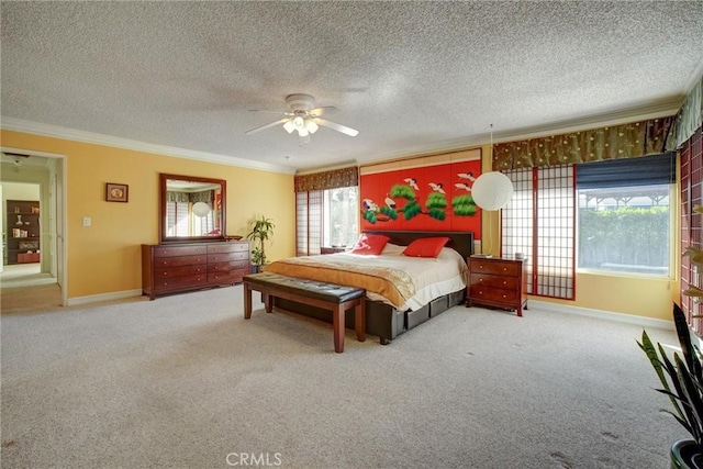 bedroom with a textured ceiling, ceiling fan, ornamental molding, and carpet flooring