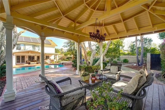 view of patio with an outdoor hangout area, a pool side deck, and a gazebo