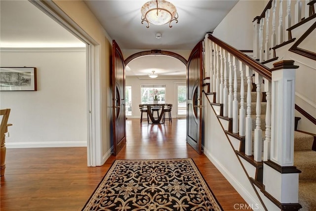 corridor with hardwood / wood-style flooring