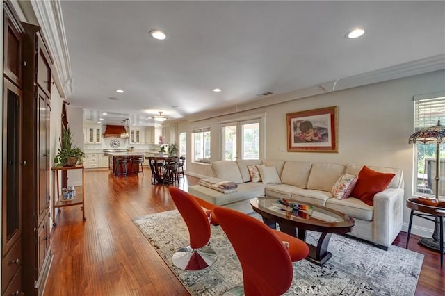 living room with ornamental molding and hardwood / wood-style flooring