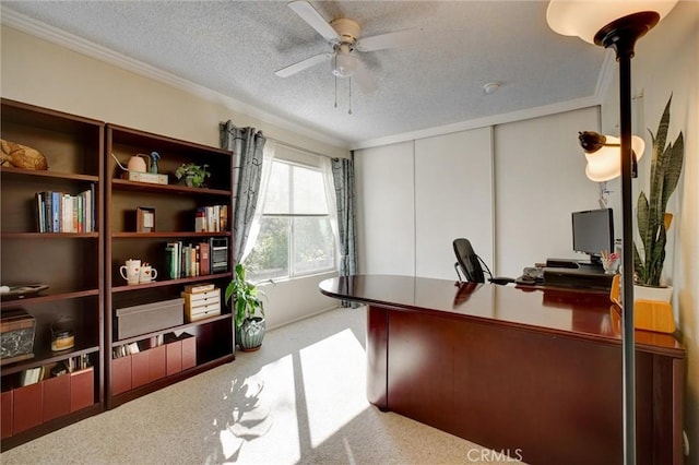 office area featuring carpet floors, a textured ceiling, crown molding, and ceiling fan