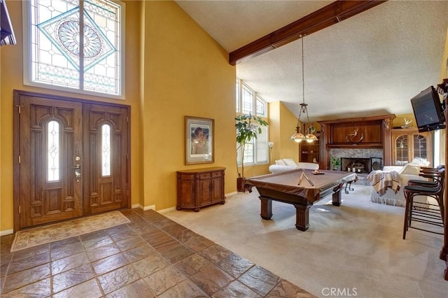 rec room featuring high vaulted ceiling, a premium fireplace, pool table, and beamed ceiling