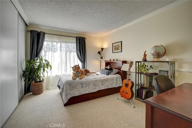 bedroom with a textured ceiling, ornamental molding, and carpet floors