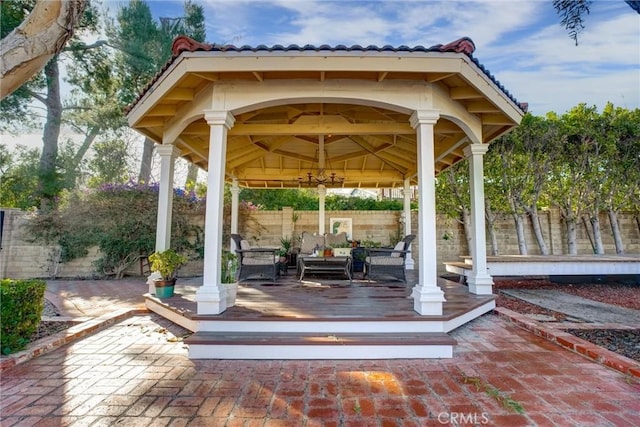 view of community featuring a patio area, a deck, a gazebo, and an outdoor living space