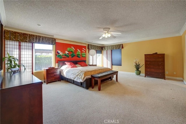 bedroom featuring ceiling fan, a textured ceiling, ornamental molding, and carpet flooring