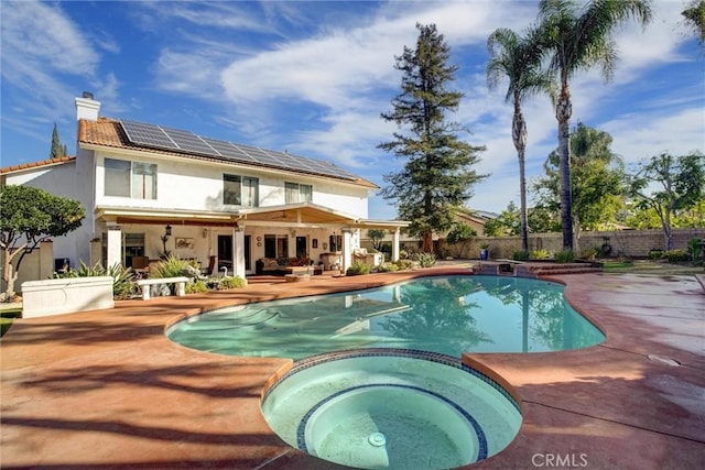 view of swimming pool featuring an in ground hot tub and a patio area