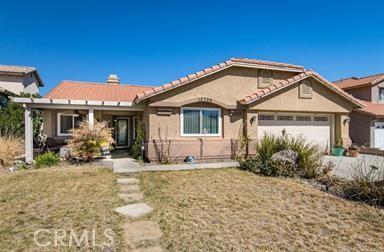 single story home featuring a garage and a front lawn